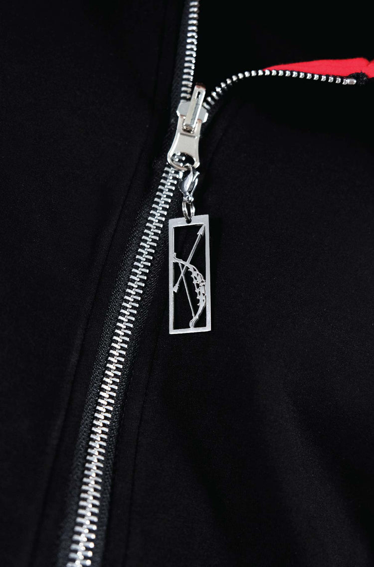Showcasing archer zipper charm on zip up from Torokami Apparel