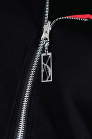 Showcasing archer zipper charm on zip up from Torokami Apparel